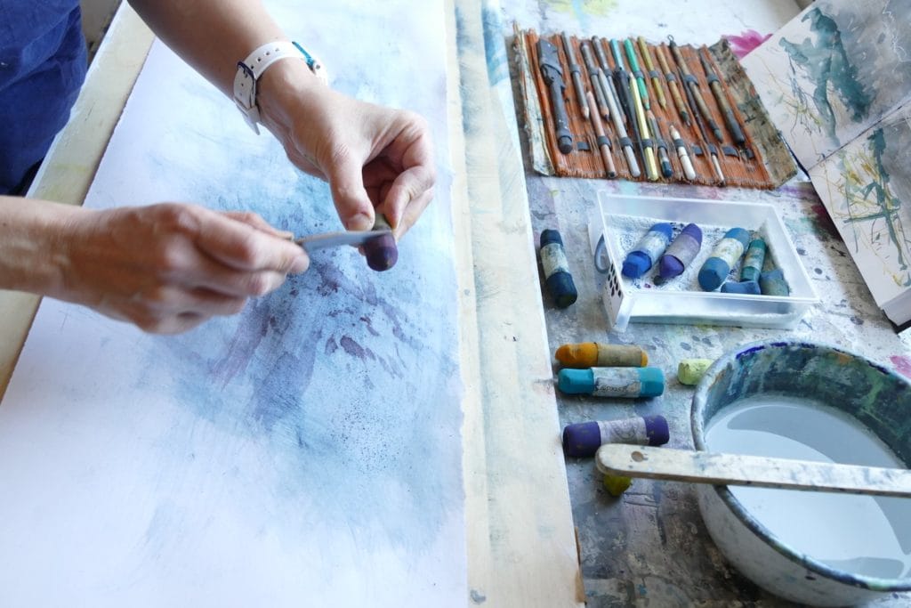 Libby uses a knife to create pastel shards.