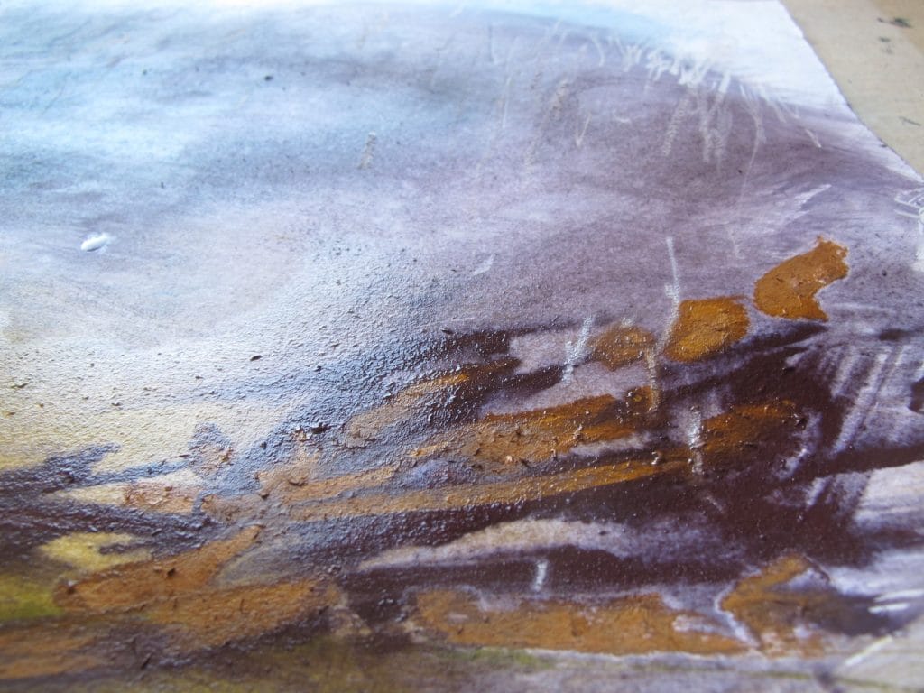 A close up of a pastel painting, with reflecting light bouncing off the wet surface.