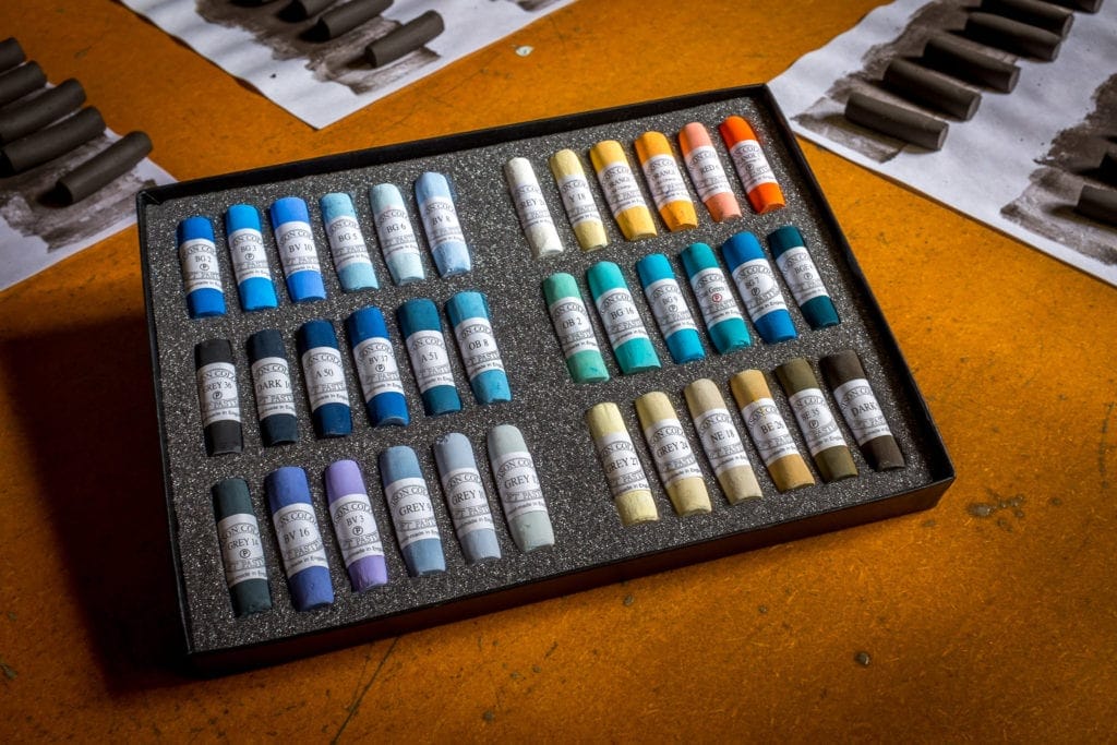 An open box of the Michelle Lucking Beach Set, pastels.