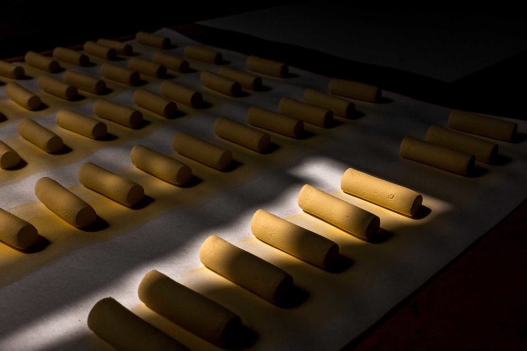 Freshly rolled golden pastels, sunlit by a narrow beam of light.