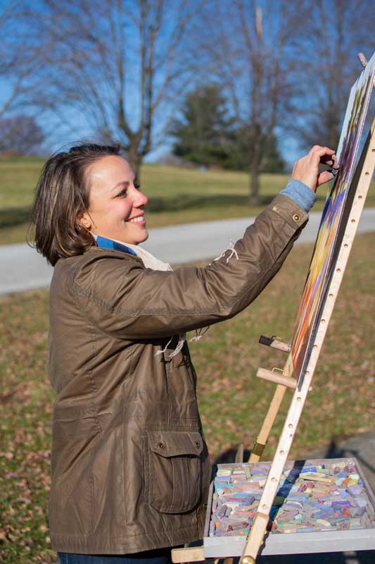 Portrait photo of Tara at her easel.