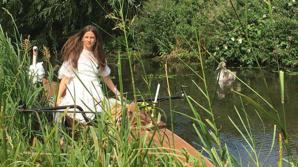 Women in a rowing boat, during the reenactment of the original painting 'Lady of Shalott'.