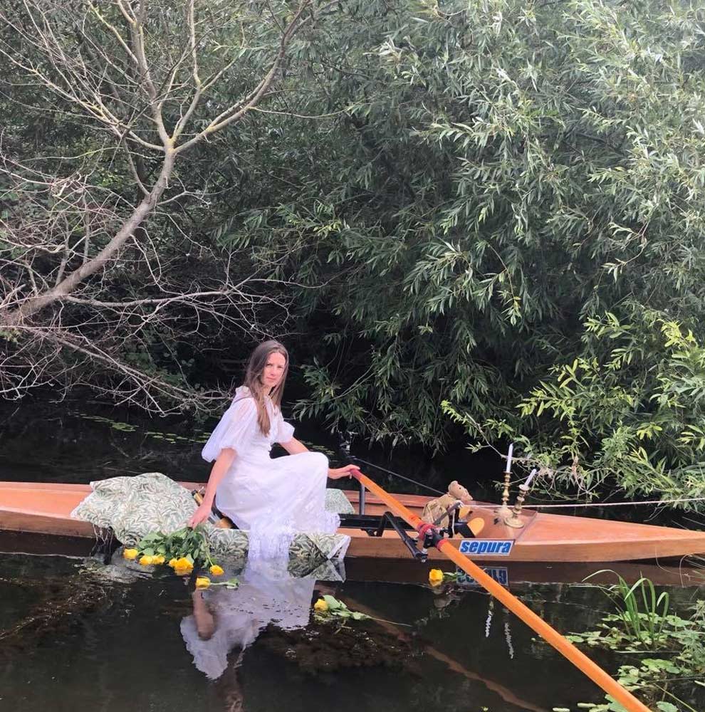 Women in a rowing boat, during the reenactment of the original painting 'Lady of Shalott'.