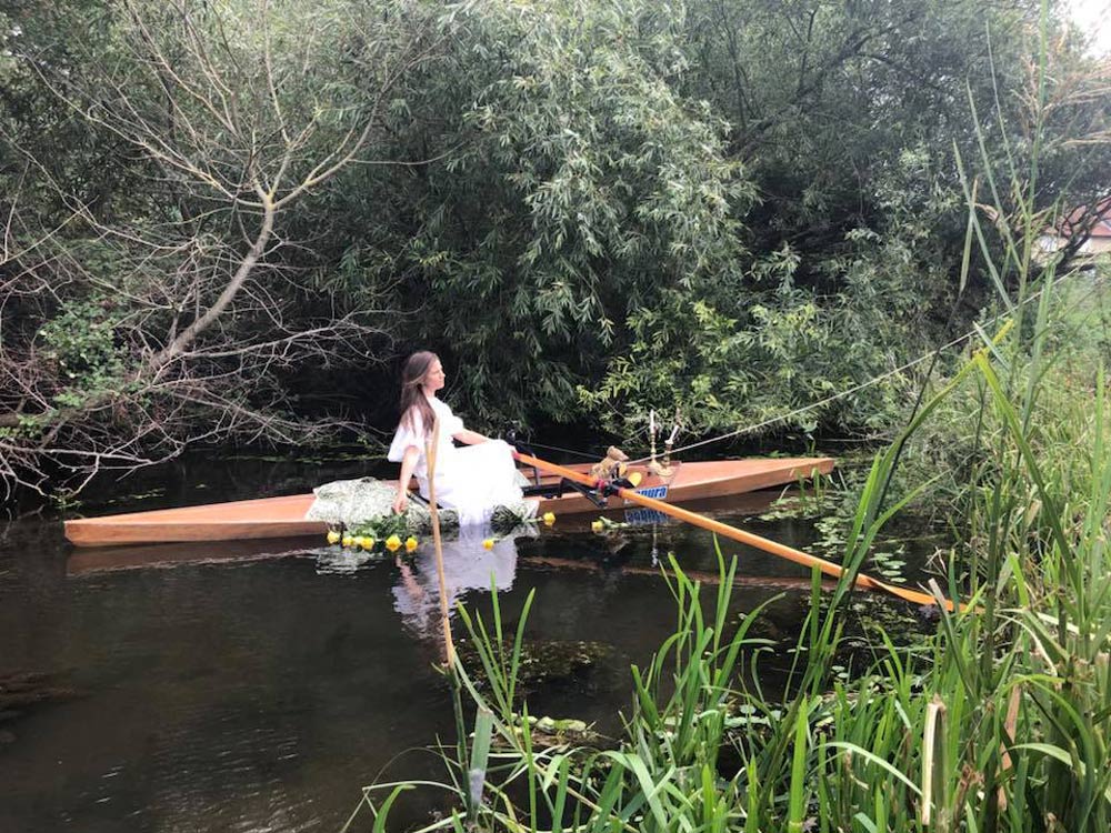 Women in a rowing boat, during the reenactment of the original painting 'Lady of Shalott'.