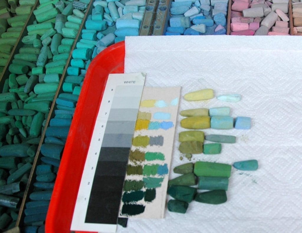 Selection of pastels with grey scale and colour swatches.