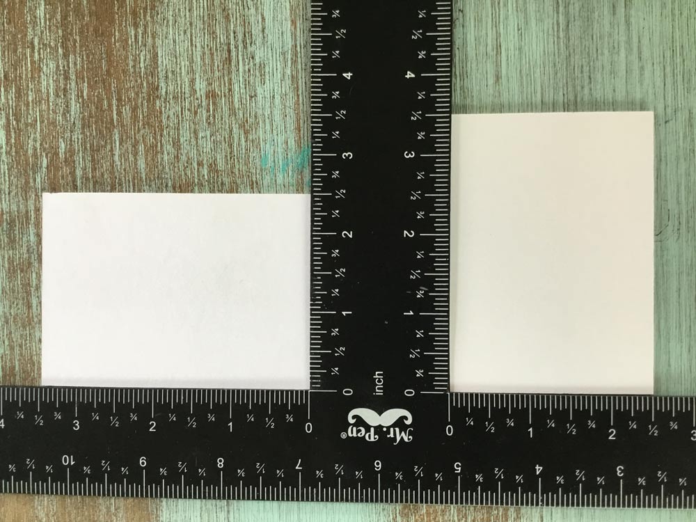 Rulers being used to measure the cards.