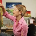 Lucy Pittaway painting in her studio.