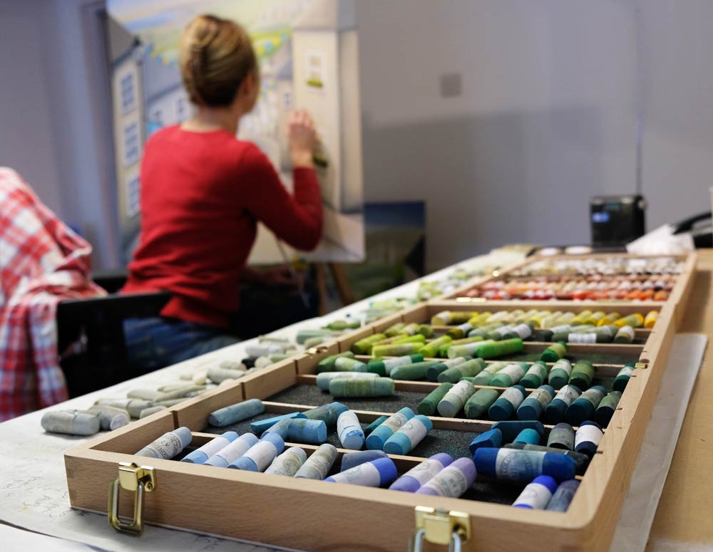 Lucy Pittaway painting in her studio.