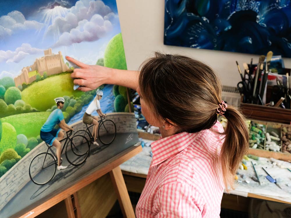 Lucy Pittaway painting a Tour de Yorkshire artwork in her studio.