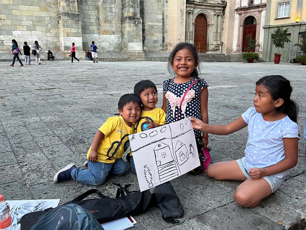 Small children enjoy painting on the street.