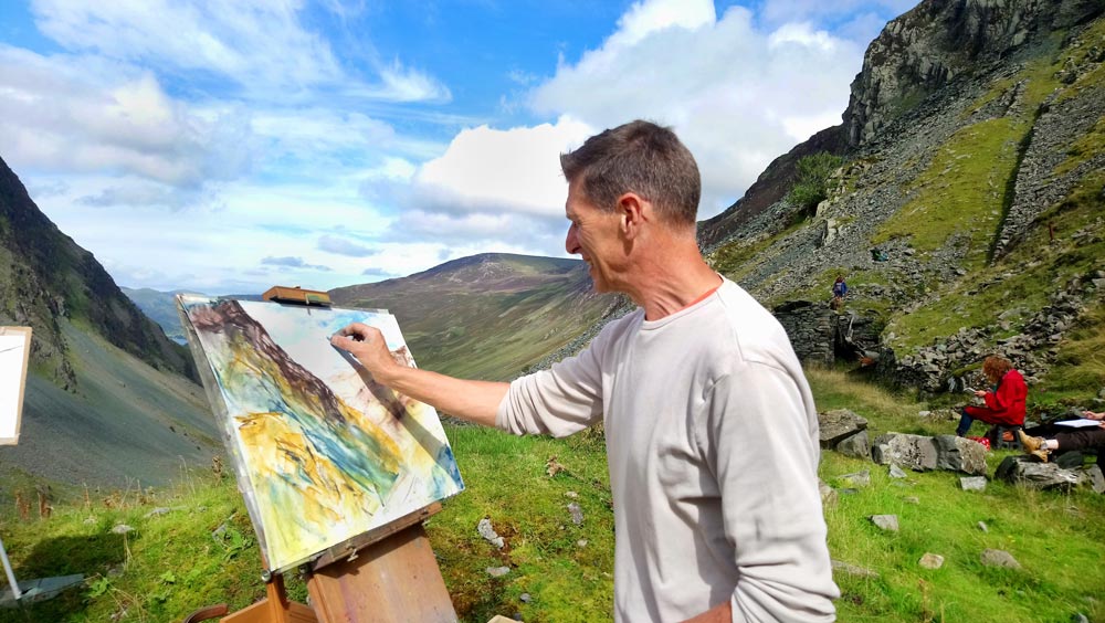 Andy pastel painting at Honister Pass as part of Robert’s art holiday from Higham Hall near Keswick enjoying the fresh air and great landscape colours in the mountains of Lakeland.