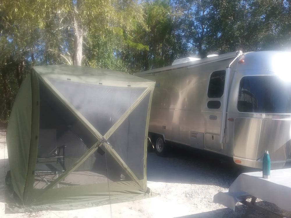 A gazebo style tent with mesh sides.