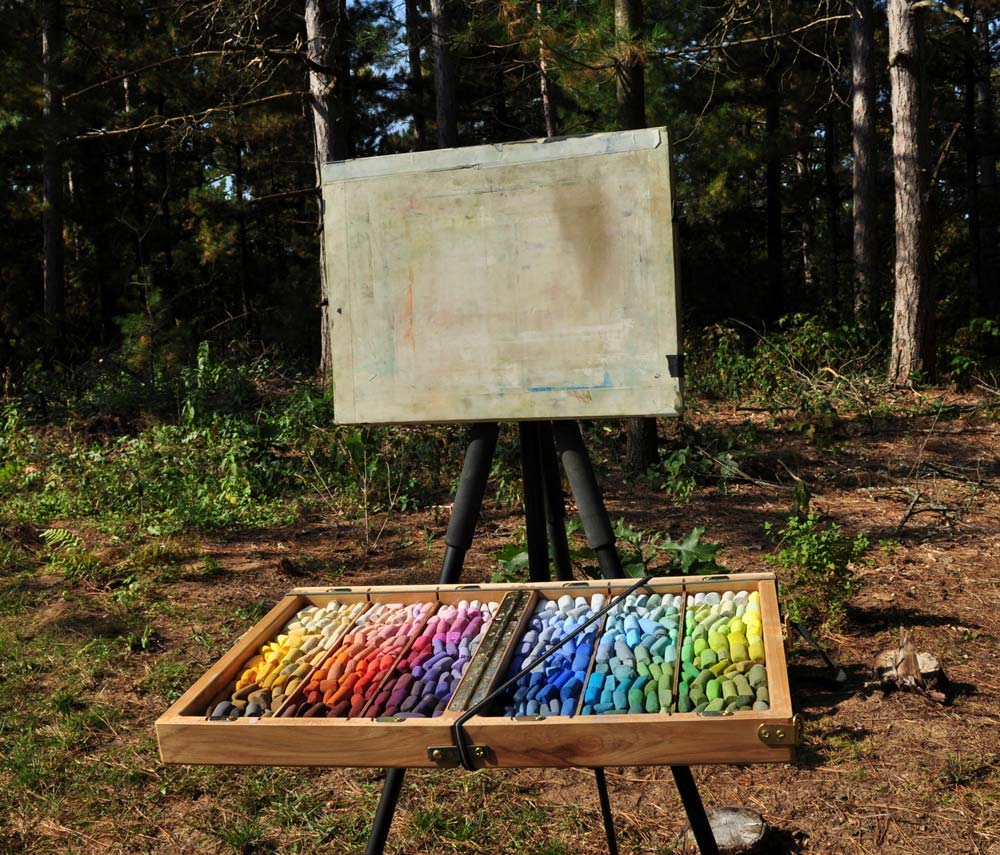 Susan's large tray of soft pastels and easel out in the countryside.