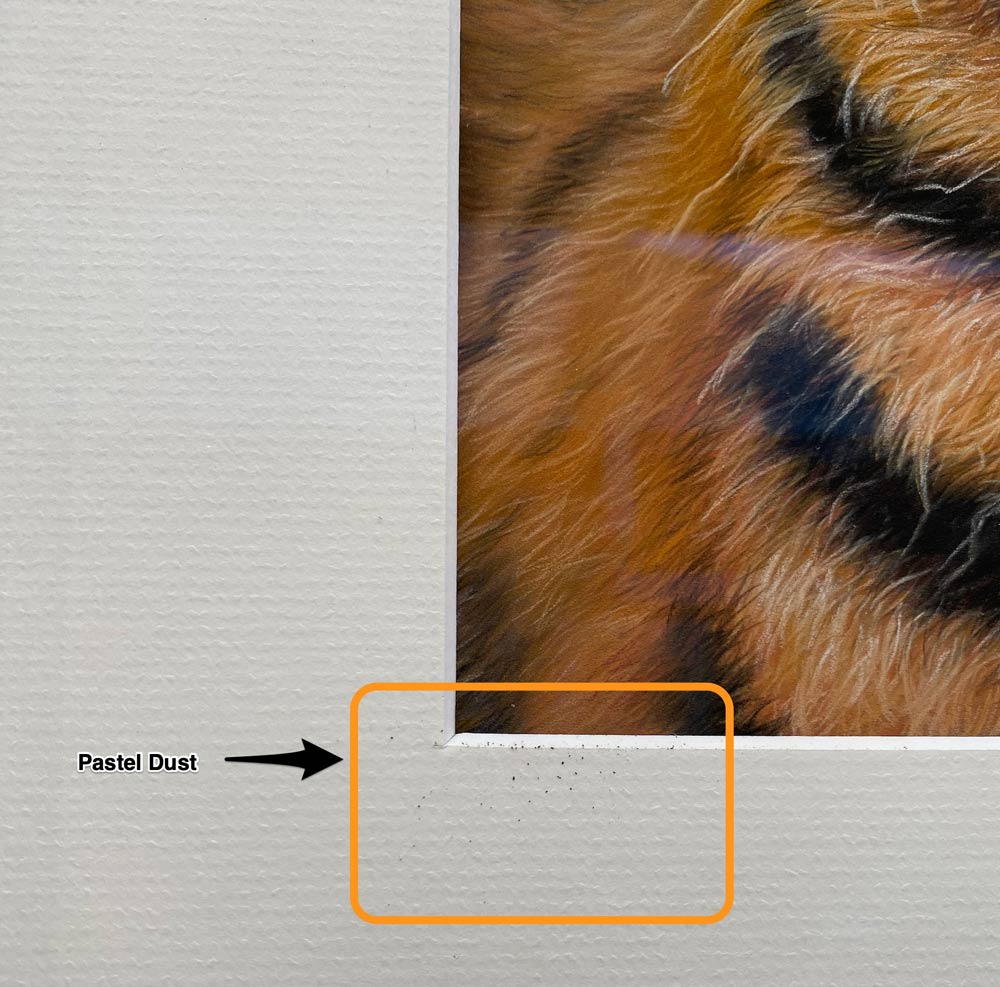 Pastel dust on the frame of the Tiger painting.