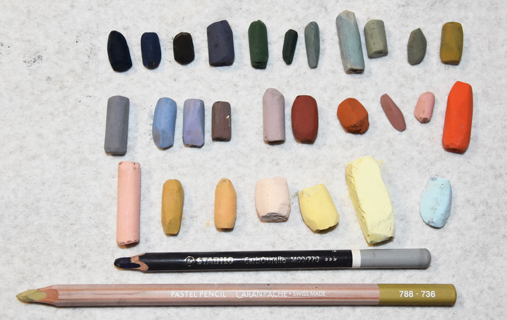 Tracey's pastels and pastel pencils laid out neatly, organised by colour.