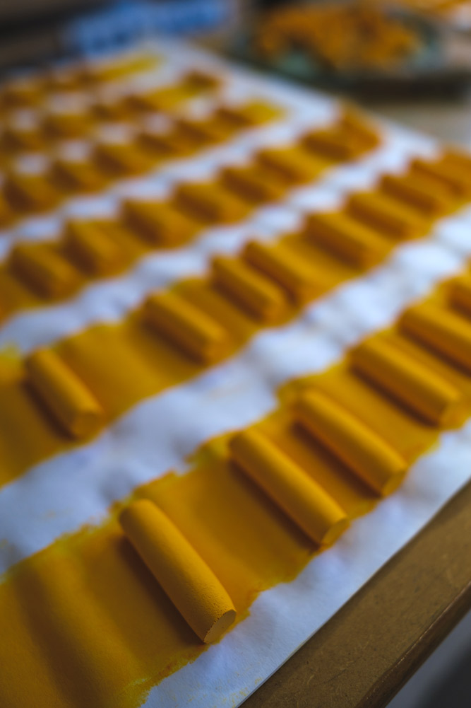 Yellow pastels, neatly cut in rows.