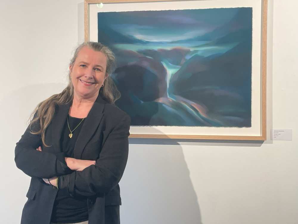 Kristin Holm Dybvig poses by one of her paintings at The Sill.