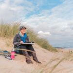 Nina Squire paints em plein air at the beach.