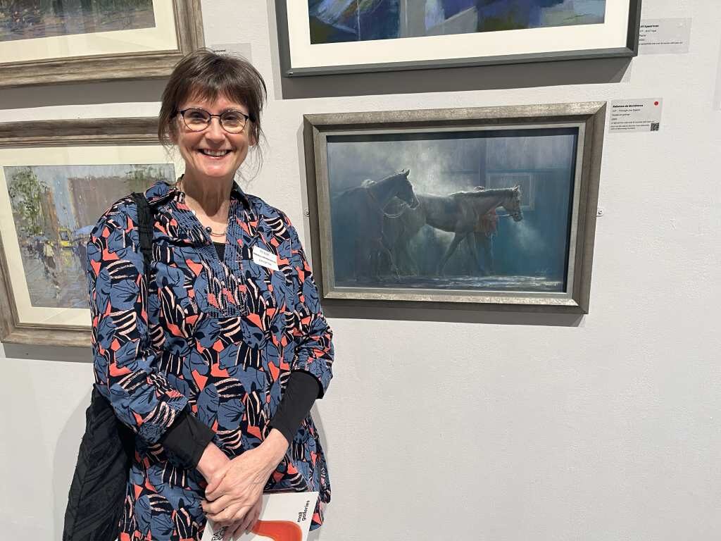 Rebecca de Mendonça standing by her painting 'Through the Steam'.