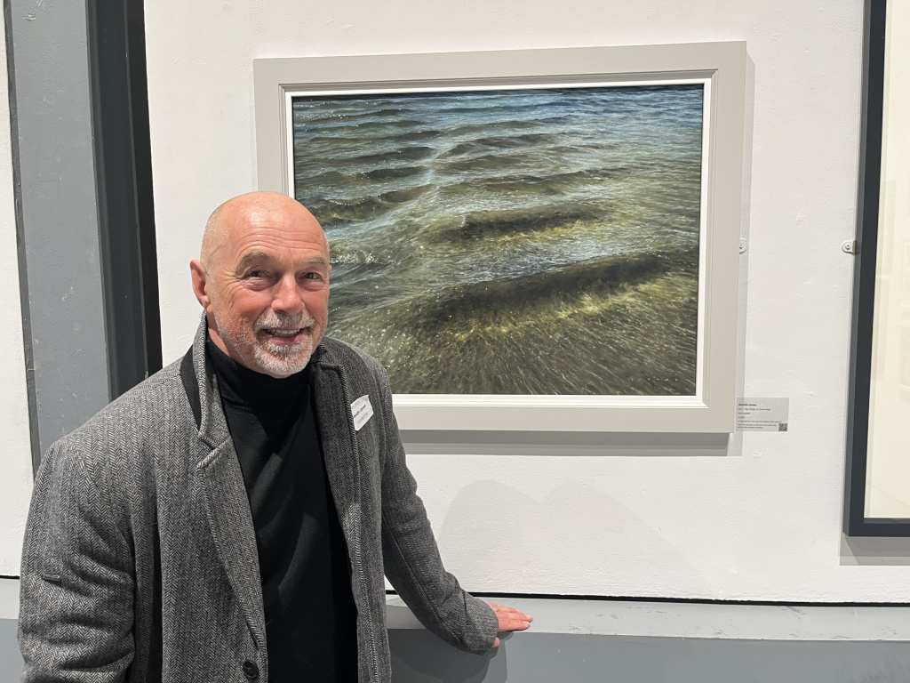 Gareth Jones stands in front of his painting 'The Power of Calmness'.