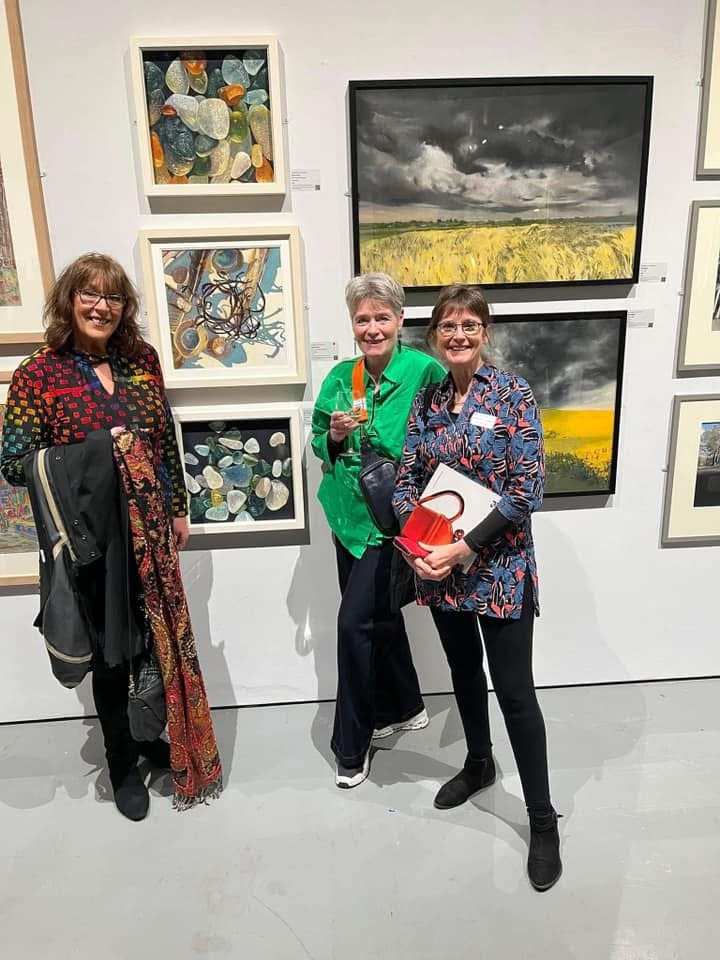 Lynn, Cathy and Rebecca pose together at the exhibition.